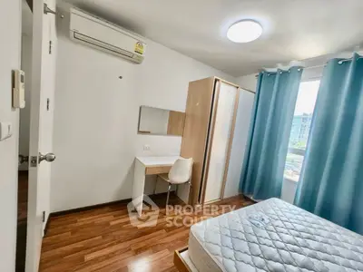 Modern bedroom with hardwood floors, air conditioning, and natural light