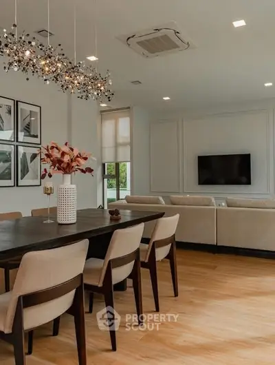 Elegant living room with modern dining area and stylish chandelier