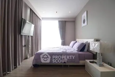 Modern bedroom with sleek design, featuring a large window, stylish curtains, and a mounted flat-screen TV.