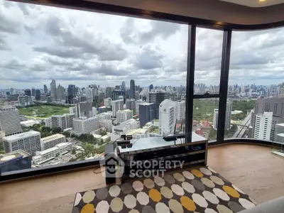 Stunning cityscape view from modern high-rise apartment living room with floor-to-ceiling windows.