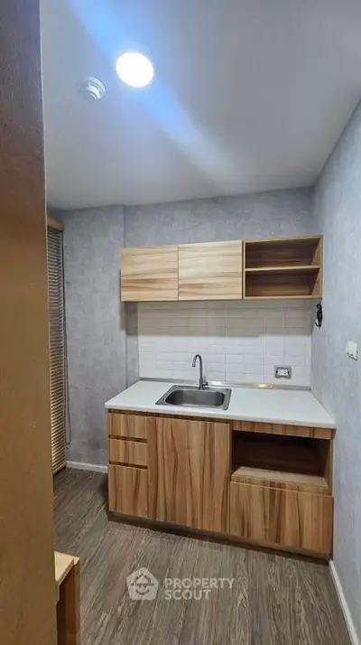 Modern compact kitchen with wooden cabinets and sleek design