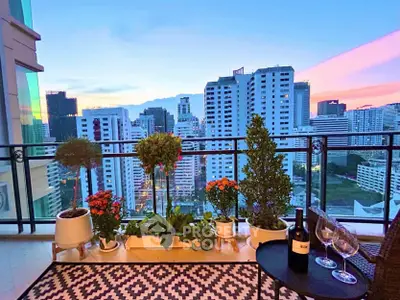 Stunning balcony view with city skyline and elegant decor at sunset.