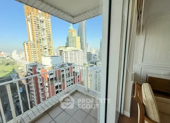 Stunning city view from a high-rise balcony with modern urban skyline.