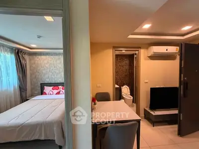 Cozy studio apartment with modern decor, featuring a bedroom and compact living area.