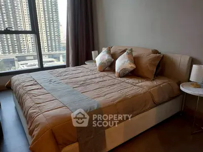 Luxurious bedroom with city view and elegant decor in modern apartment.