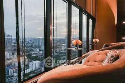 Luxurious high-rise living room with panoramic city view and elegant decor.
