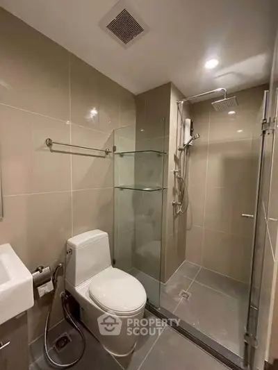 Modern bathroom with glass shower and sleek fixtures