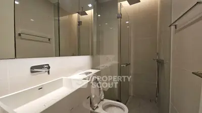 Modern bathroom with sleek fixtures and glass shower enclosure