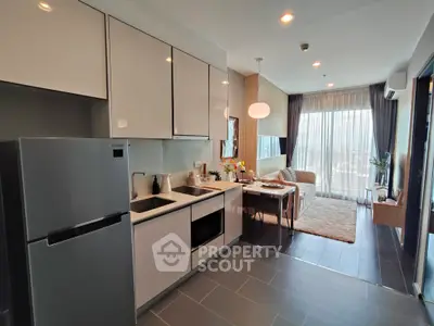 Modern open-layout kitchen and living room with sleek design and natural light