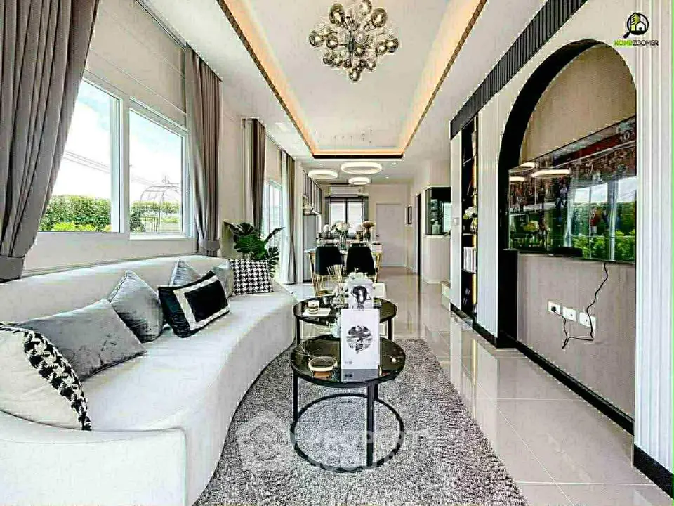 Luxurious modern living room with elegant decor and large windows offering natural light