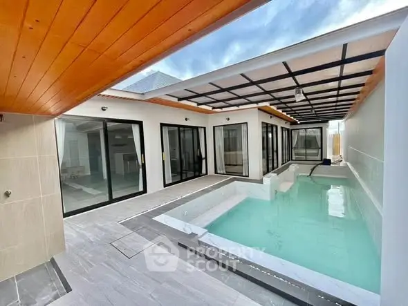 Modern home with sleek indoor pool and glass doors, perfect for luxury living.