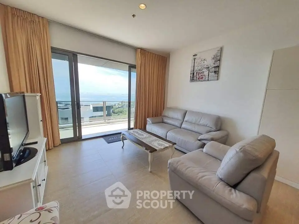 Spacious living room with modern furniture and stunning balcony view