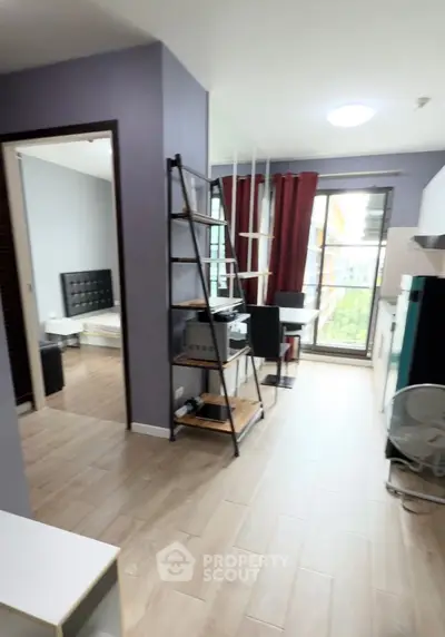 Modern apartment interior with open layout, featuring stylish furniture and large windows for natural light.