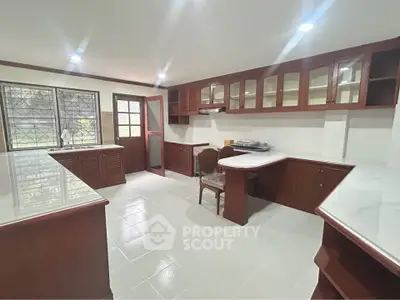 Spacious kitchen with elegant wooden cabinetry and ample natural light
