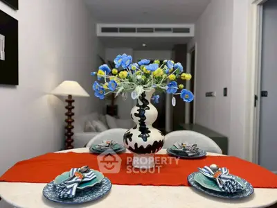 Elegant dining setup with floral centerpiece in modern apartment interior