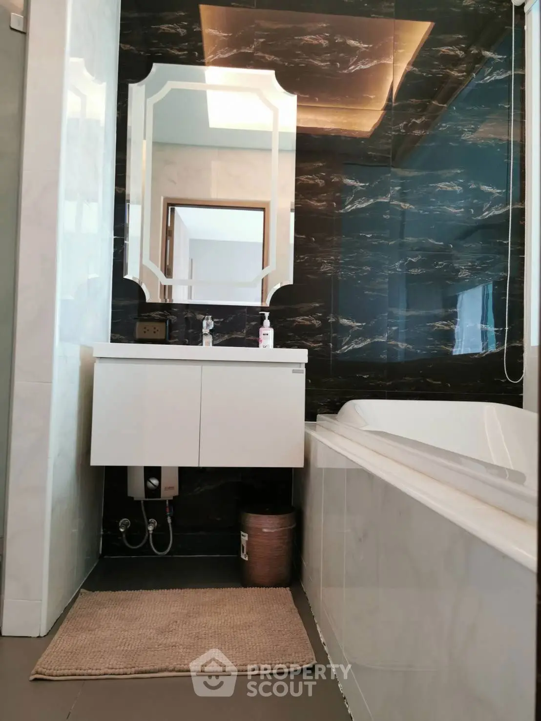 Luxurious modern bathroom with elegant marble walls and stylish vanity.