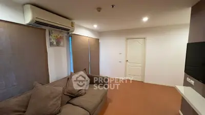 Cozy living room with modern air conditioning and comfortable sofa in a stylish apartment.
