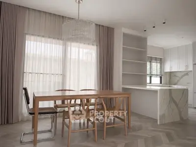 Modern dining area with elegant wooden table and open kitchen layout in a stylish apartment.
