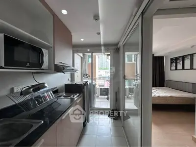 Modern apartment kitchen with open layout and balcony view