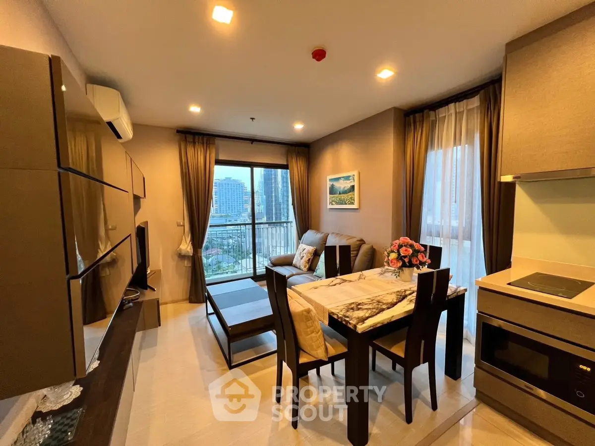 Modern living room with open layout, stylish furniture, and city view balcony in luxury apartment.