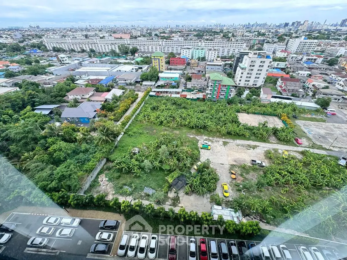 Stunning aerial view of urban landscape with lush greenery and city skyline, perfect for real estate development.