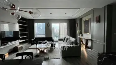 Spacious modern living room with city view, elegant decor, and ample natural light.