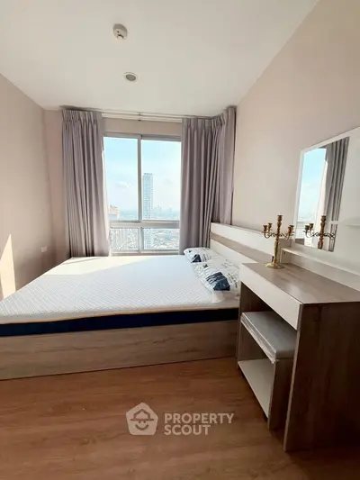 Modern bedroom with city view, featuring sleek furniture and large windows for natural light.