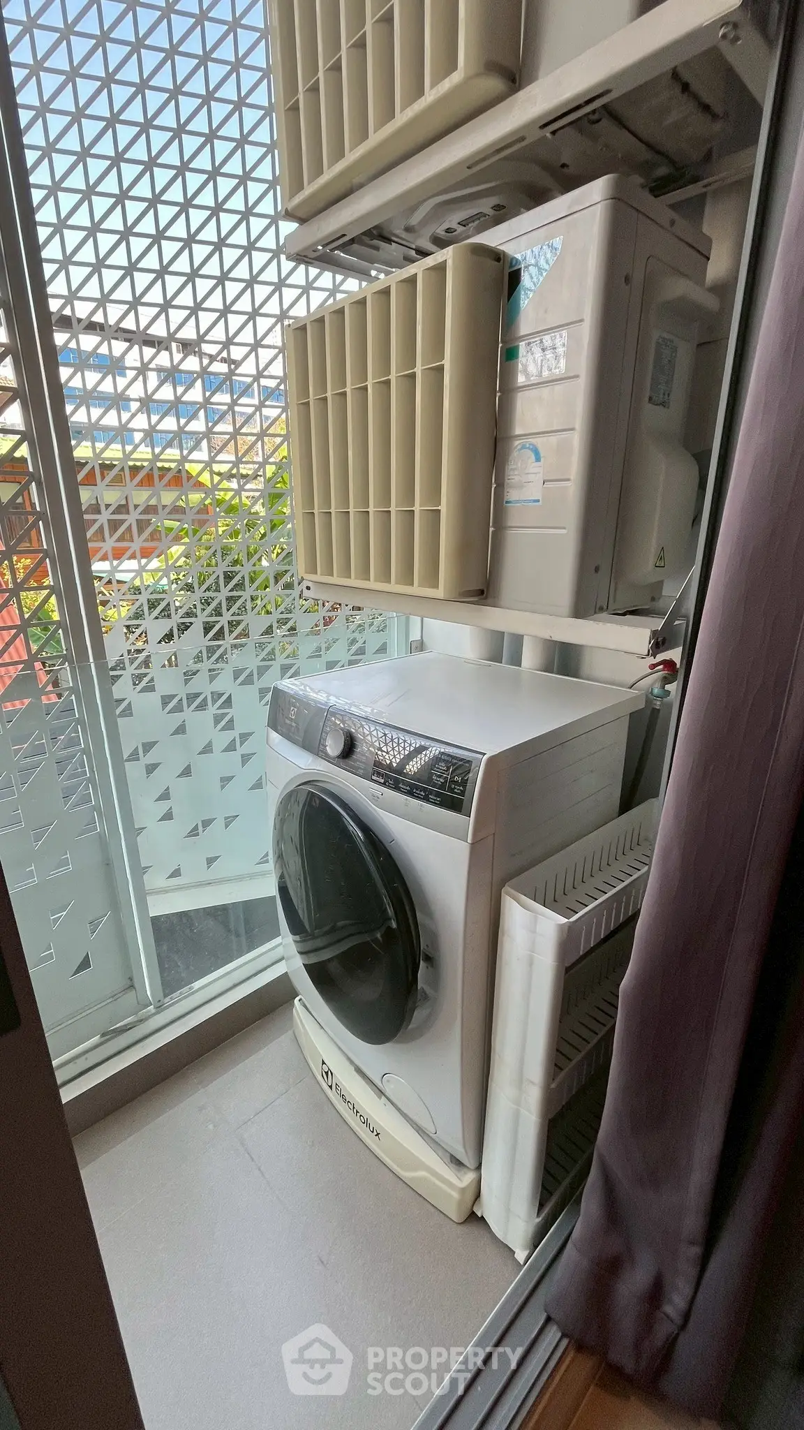 Compact laundry area with washing machine and outdoor view in modern apartment.