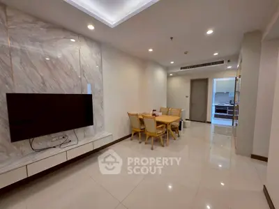 Spacious modern living room with elegant dining area and sleek TV setup