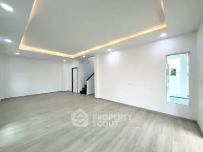 Spacious modern living room with elegant lighting and wooden flooring