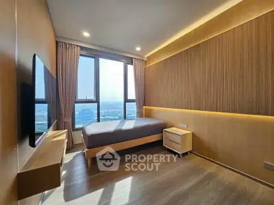 Modern bedroom with large windows and wooden accents offering stunning city views.
