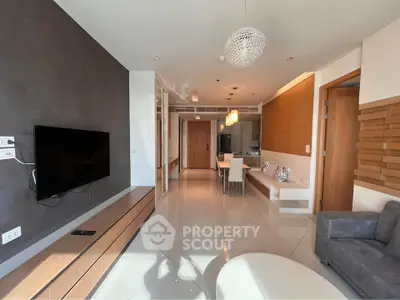 Modern living room with sleek design and open layout, featuring stylish furniture and ambient lighting.