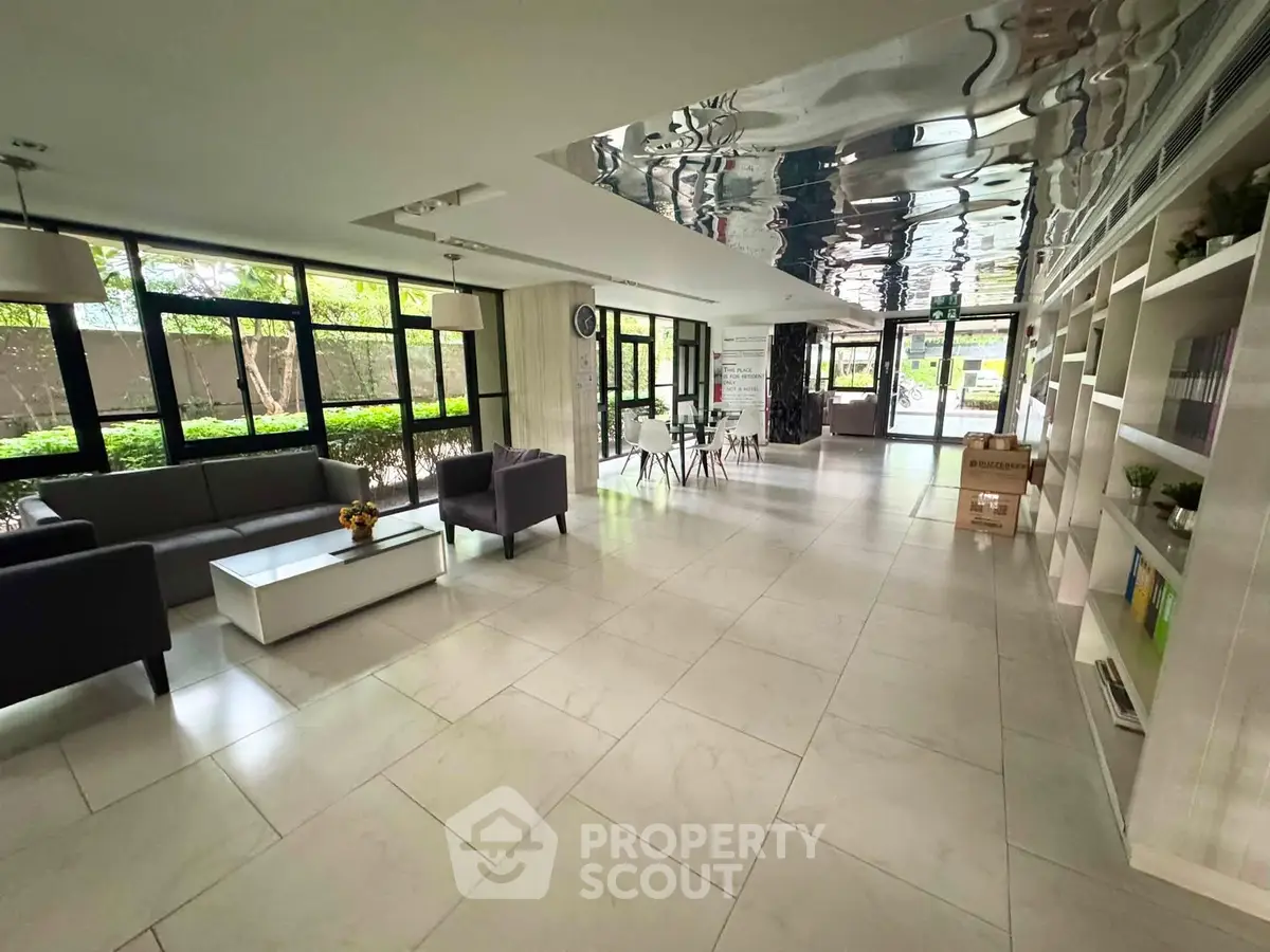 Spacious modern lobby with sleek design and ample natural light, perfect for welcoming guests.