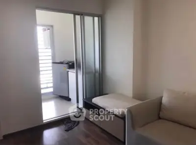 Modern apartment interior with sliding door and cozy seating area