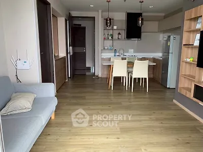 Modern open-layout kitchen and living area with sleek design and wooden flooring