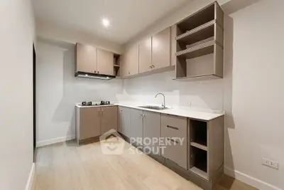 Modern kitchen with sleek cabinetry and gas stove in a contemporary apartment.