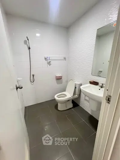 Modern bathroom with sleek white tiles and contemporary fixtures