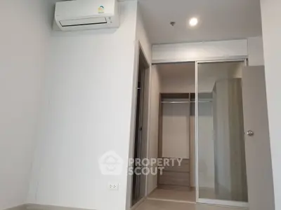 Modern bedroom with built-in closet and air conditioning unit