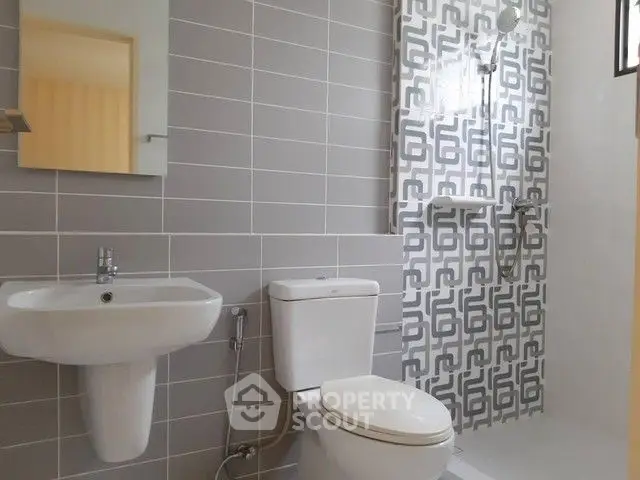 Modern bathroom with stylish tile design and sleek fixtures.