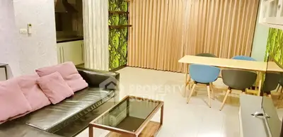 Modern living room with stylish decor and open layout, featuring a cozy seating area and dining space.