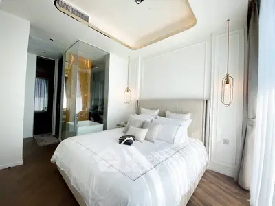 Luxurious bedroom with elegant lighting and modern decor in a high-end apartment.