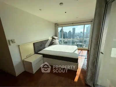 Spacious bedroom with stunning city view in modern high-rise apartment