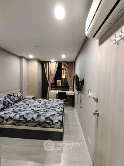 Modern bedroom with stylish decor and air conditioning in a cozy apartment.