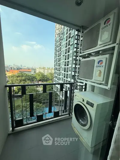 Modern balcony with city view, washing machine, and air conditioning units in high-rise apartment.
