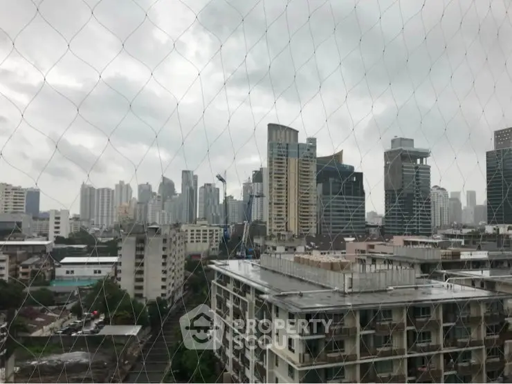 Stunning cityscape view from high-rise building showcasing urban skyline and modern architecture.