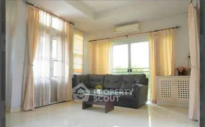 Bright living room with large windows and modern furnishings
