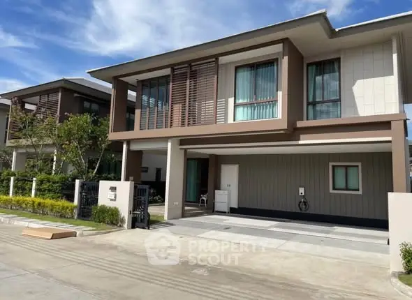 Modern two-story house with sleek design and spacious driveway
