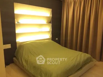 Cozy bedroom with modern lighting and elegant curtains, perfect for relaxation.