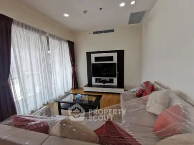Spacious living room with modern decor and large windows for natural light.