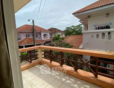 Charming balcony with tiled flooring and scenic neighborhood view, perfect for relaxation.